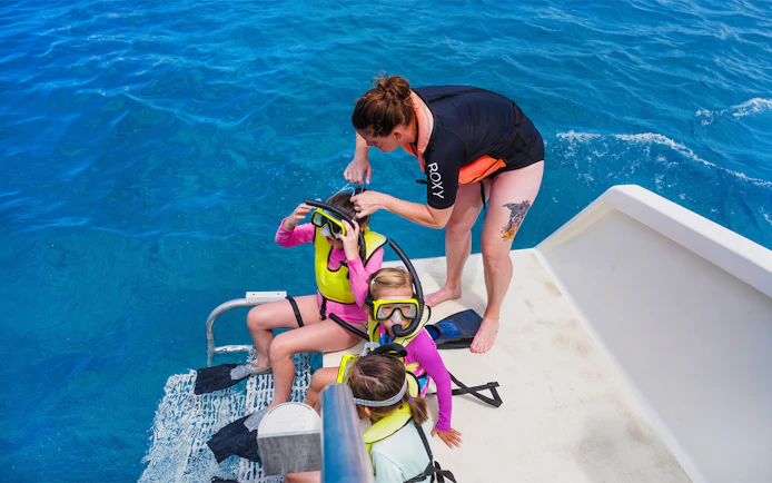 Children preparing for snorkeling on a Waikiki sail in Hawaii.