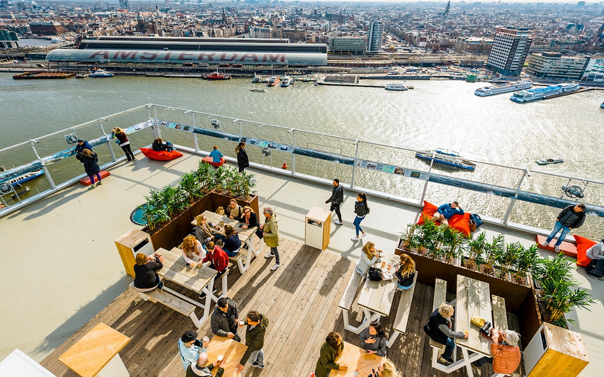 Visitors enjoying the view from ADAM Lookout panorama deck in Amsterdam.