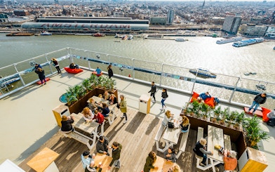 Visitors enjoying the view from ADAM Lookout panorama deck in Amsterdam.