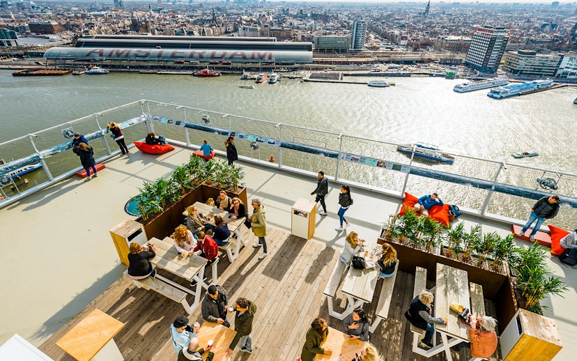 Visitors enjoying the view from ADAM Lookout panorama deck in Amsterdam.