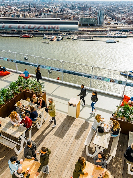 Visitors enjoying the view from ADAM Lookout panorama deck in Amsterdam.