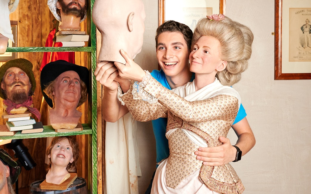 Man posing with Marie Tussaud wax figure at Madame Tussauds Berlin.