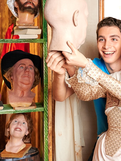 Man posing with Marie Tussaud wax figure at Madame Tussauds Berlin.