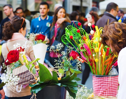Crowd browsing flower stalls during Sant Jordi festival in Barcelona.