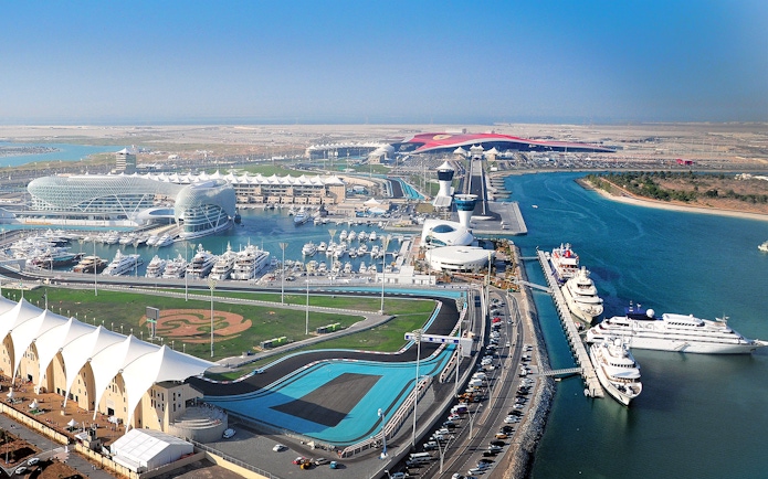 Yas Marina Circuit aerial view with yachts and racetrack in Abu Dhabi.