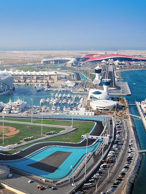 Yas Marina Circuit aerial view with yachts and racetrack in Abu Dhabi.