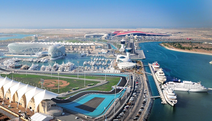 Yas Marina Circuit aerial view with yachts and racetrack in Abu Dhabi.