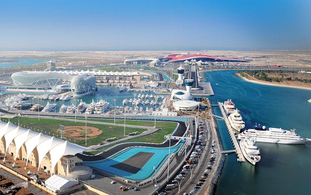Yas Marina Circuit aerial view with yachts and racetrack in Abu Dhabi.