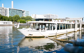 Le Diamant Bleu cruise ship docked on the Seine River in Paris.