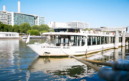 Le Diamant Bleu cruise ship docked on the Seine River in Paris.