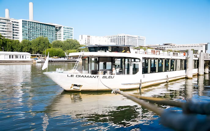 Le Diamant Bleu cruise ship docked on the Seine River in Paris.