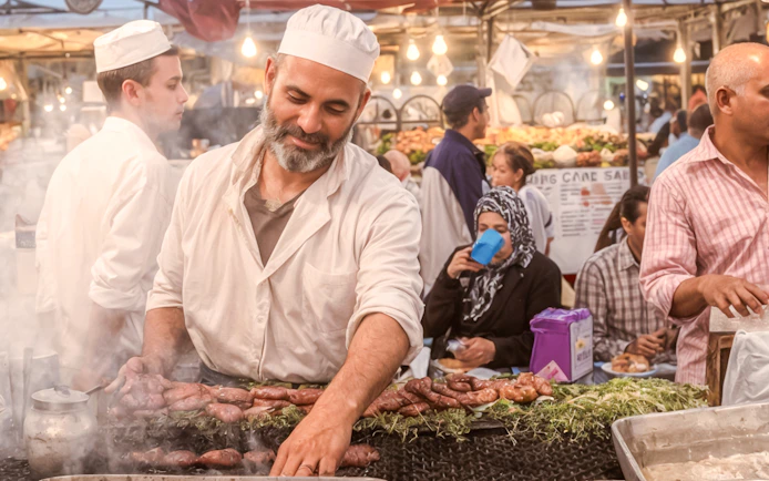 Street vendor grilling sausages at Jema el Fna, Marrakesh.