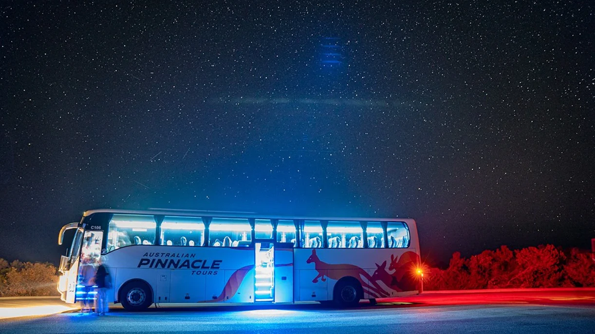 Tour bus under starry sky during Pinnacles Sunset Stargazing and Wildlife Spotting Tour.
