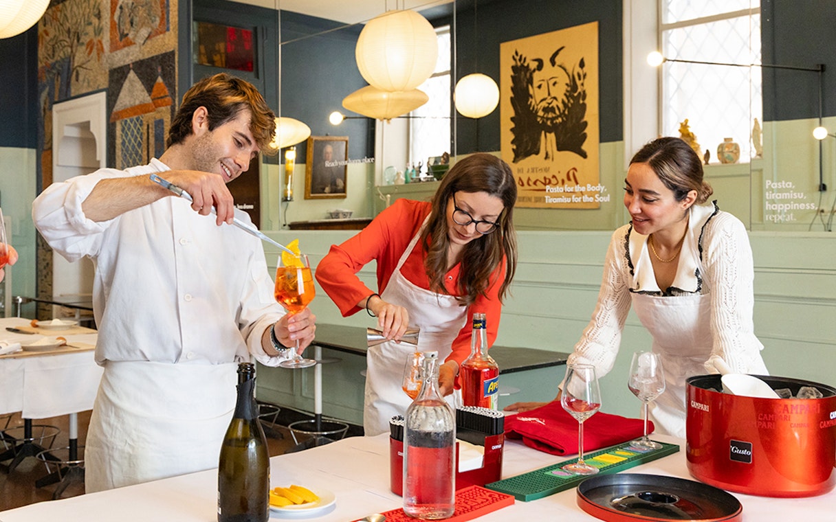 People preparing cocktails at a Rome cooking class.