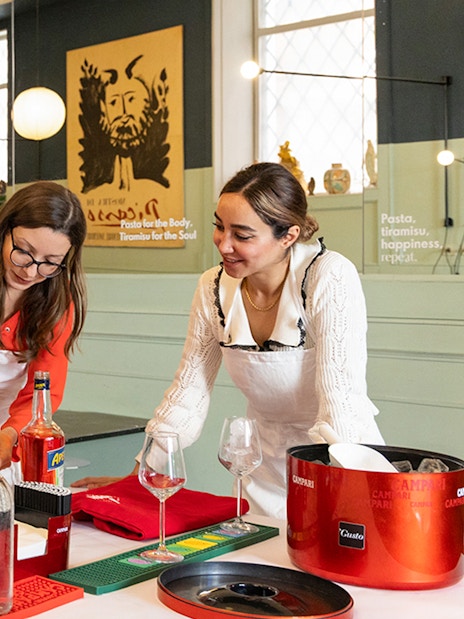 People preparing cocktails at a Rome cooking class.