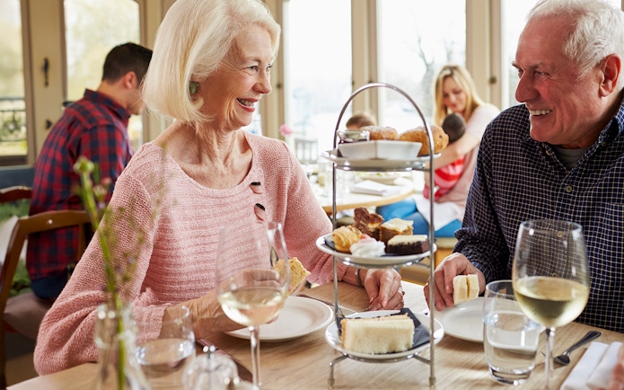Couple enjoying afternoon tea with pastries at the British Museum.