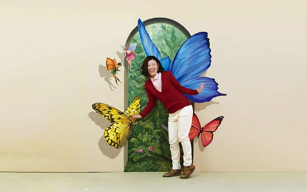 Person interacting with 3D butterfly art at Tokyo Trick Art Labyrinth Museum.
