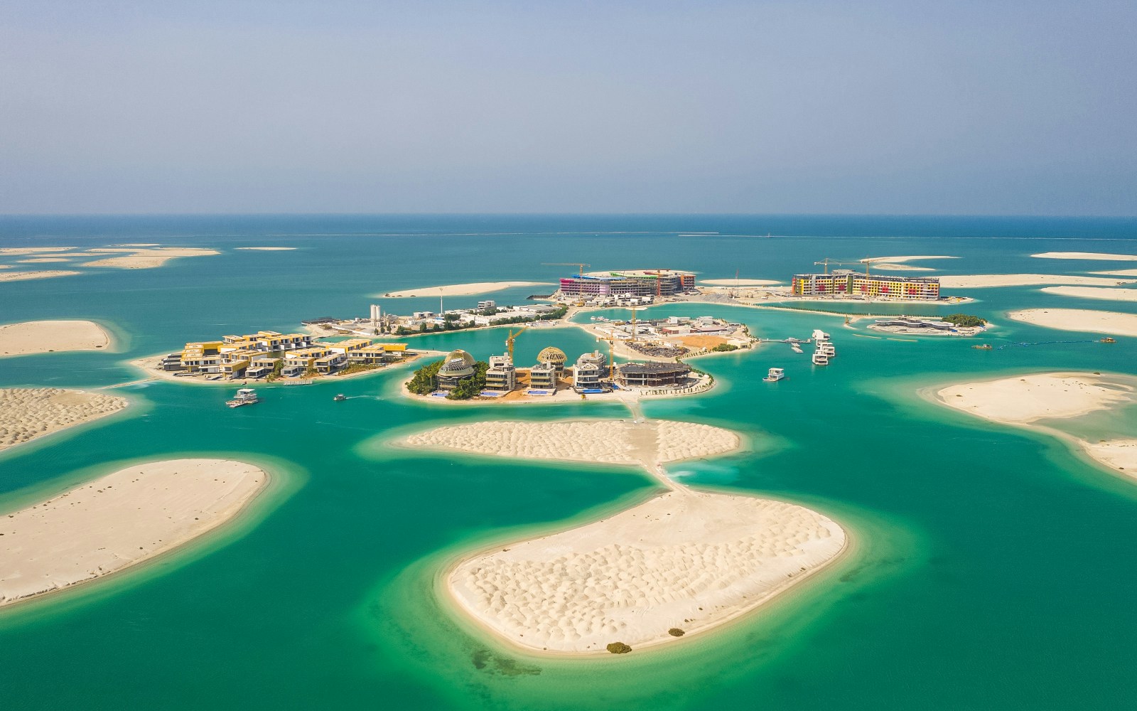 Aerial view of The World Islands, Jumeirah, Dubai, showcasing luxury villas and turquoise waters.