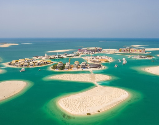 Aerial view of The World Islands, Jumeirah, Dubai, showcasing luxury villas and turquoise waters.