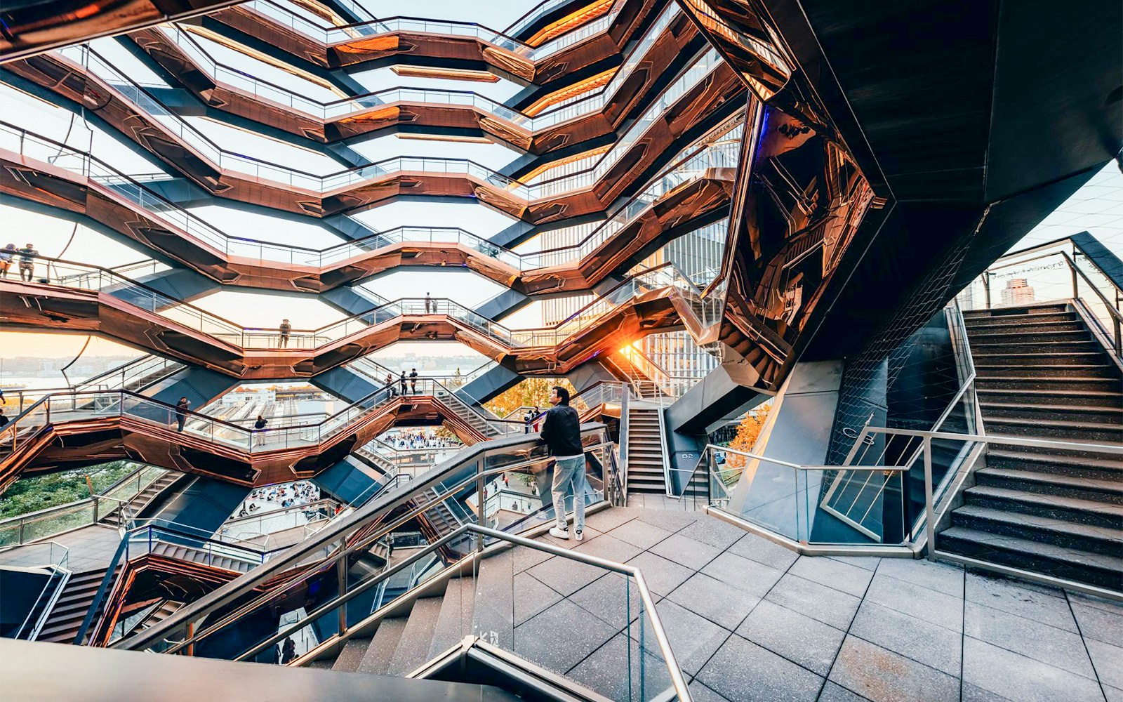 Man observing the intricate staircases of the Vessel in New York City.