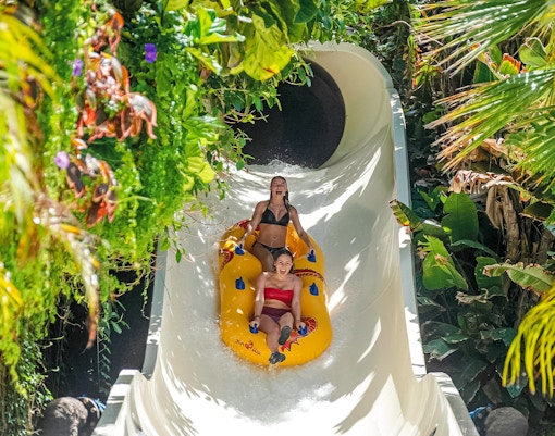 Group of excited tourists enjoying thrilling singha water slide ride with Skip-the-Line Tickets at Siam Park, Tenerife