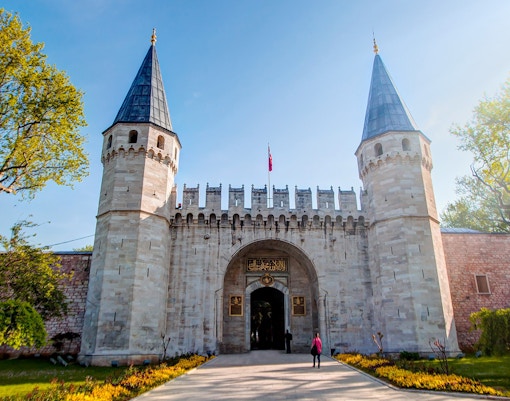 Topkapi Palace courtyard with tourists exploring in Istanbul.