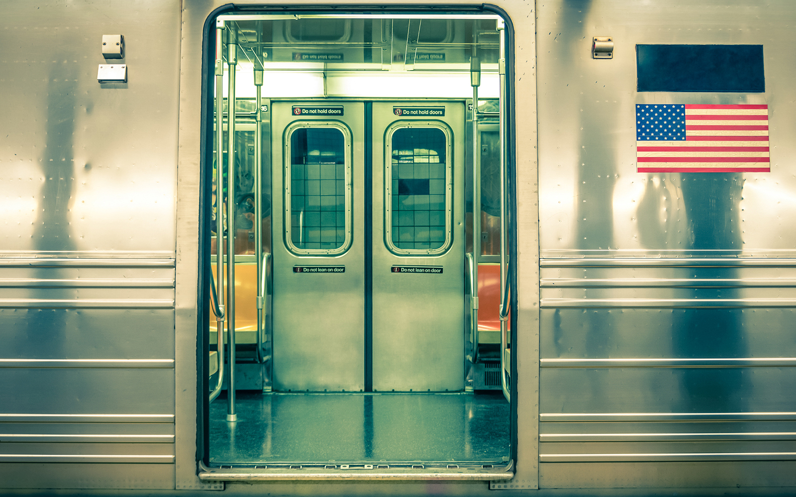 Subway train doors open, interior view, New York City.