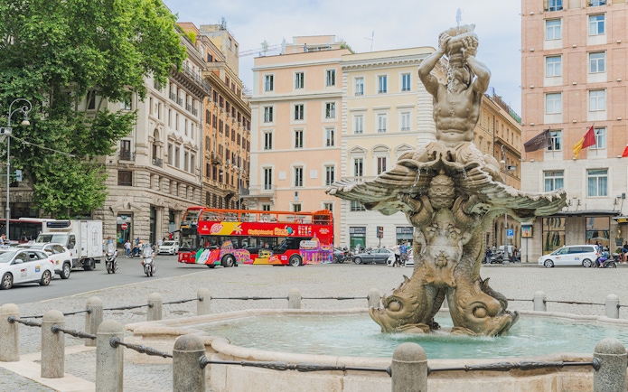 City sightseeing bus near Fontana del Tritone in Rome.