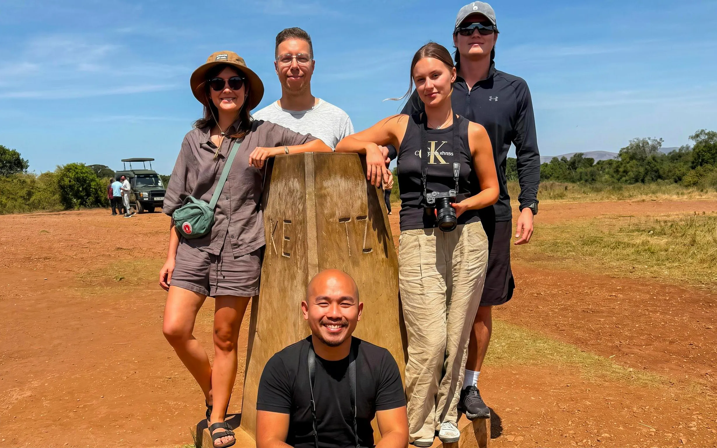 Group of tourists at the Kenya-Tanzania border during a Masai Mara Safari.