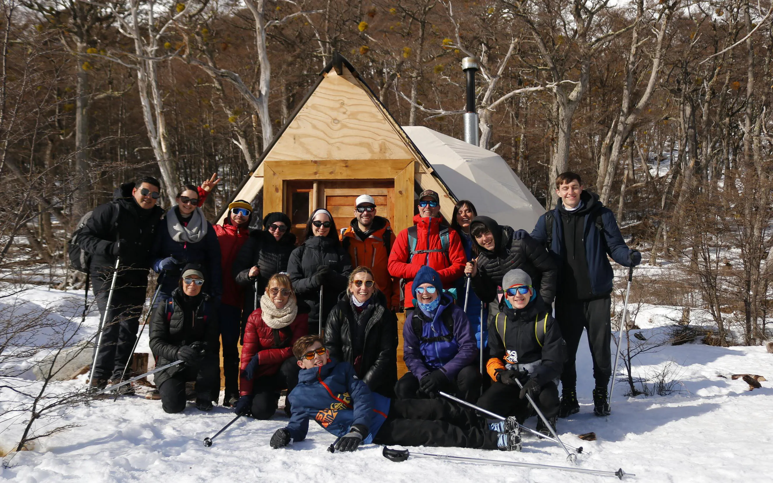 Group of trekkers posing in front of a cabin during Ojo del Albino Glacier Trekking.