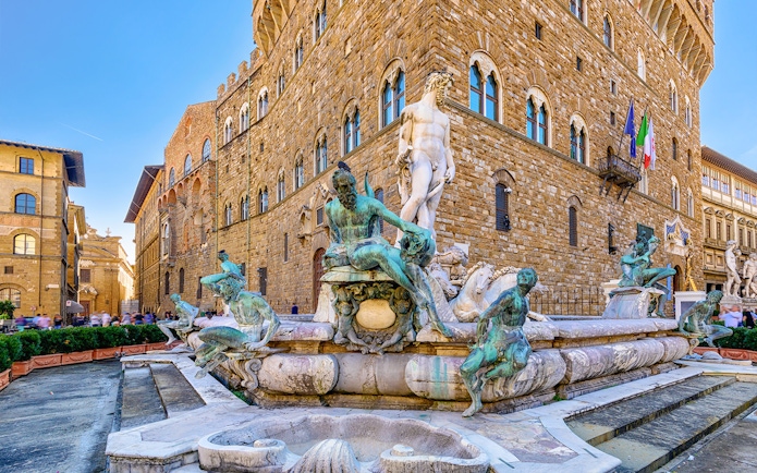 Neptune Fountain and Michelangelo's David in Piazza della Signoria, Florence, with Palazzo Vecchio.