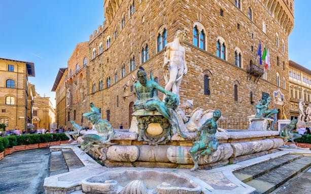 Neptune Fountain and Michelangelo's David in Piazza della Signoria, Florence, with Palazzo Vecchio.