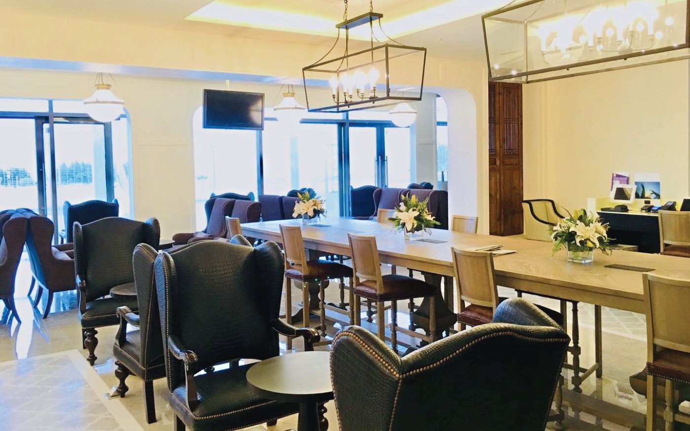 Phuket International Airport Coral Executive Lounge seating area with tables and chairs.