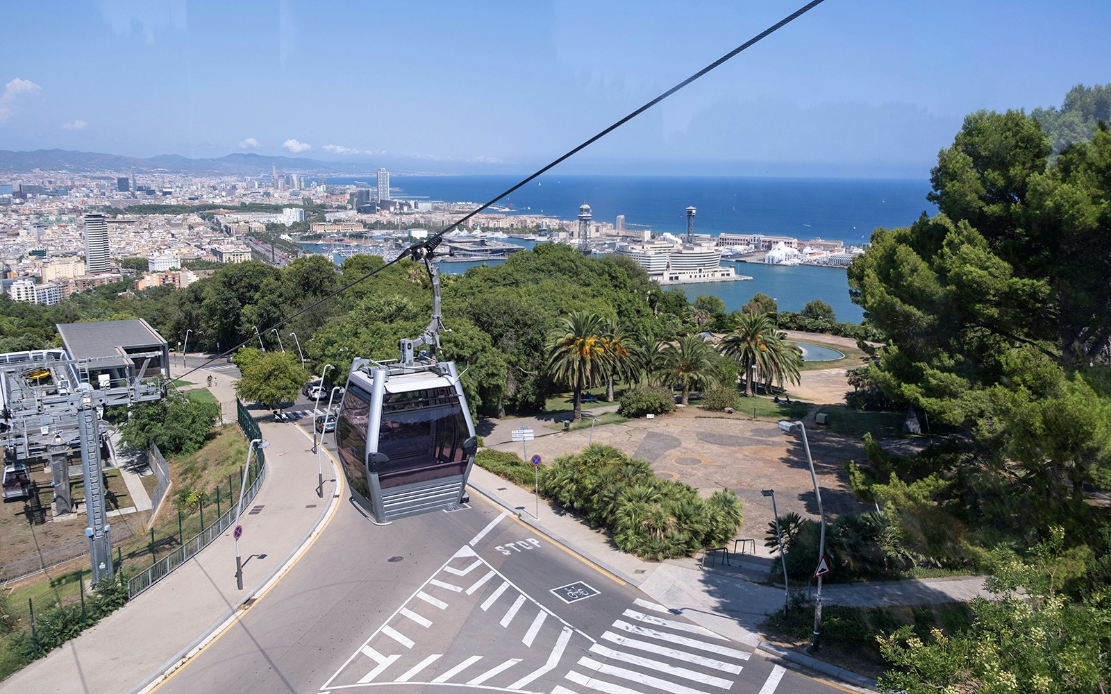 Cable car ascending Montjuic Hill with view of Sagrada Familia in back