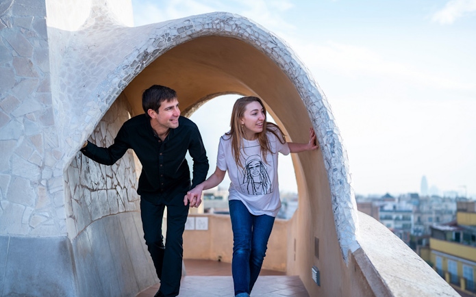 Visitors exploring the unique architecture of La Pedrera-Casa Milà terrace in Barcelona.