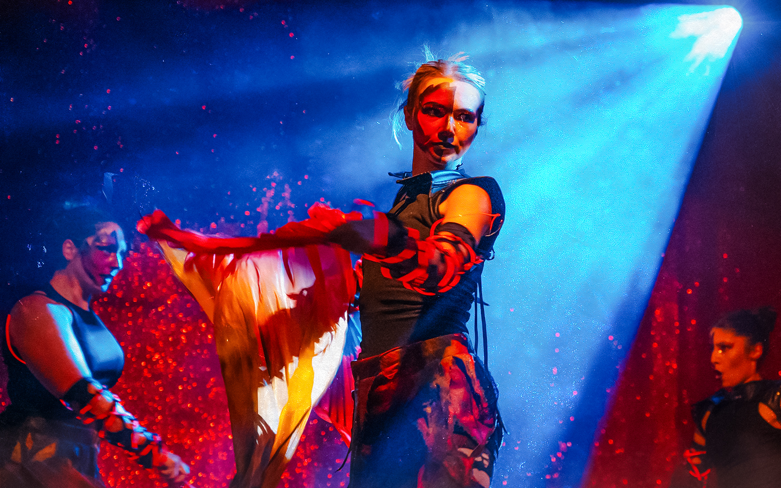 Performers in Halloween costumes at Thorpe Park show with dramatic lighting.
