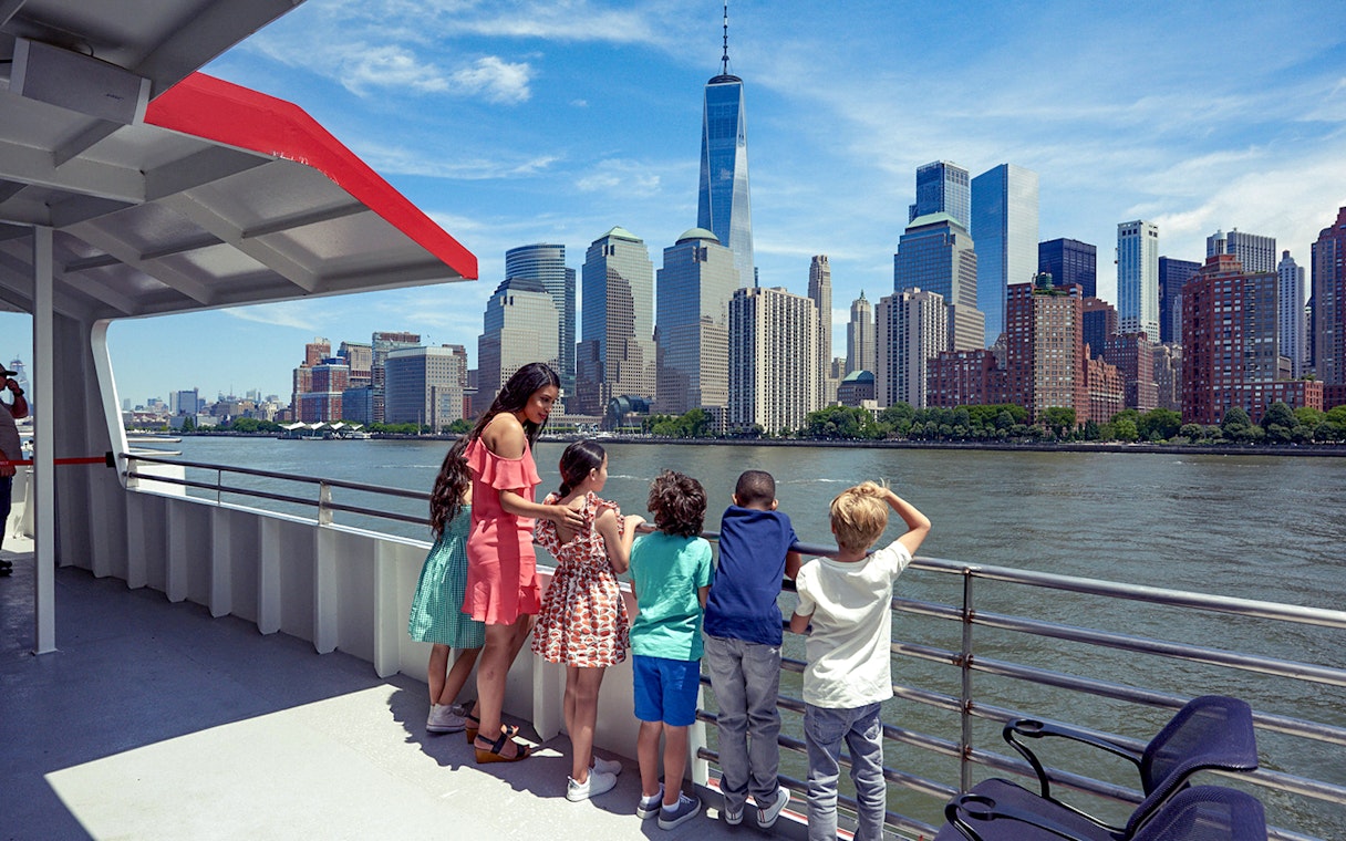 Cruise passengers view New York City skyline, including One World Trade Center, on Circle Line Liberty Midtown Cruise.