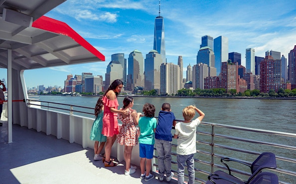 Cruise passengers view New York City skyline, including One World Trade Center, on Circle Line Liberty Midtown Cruise.
