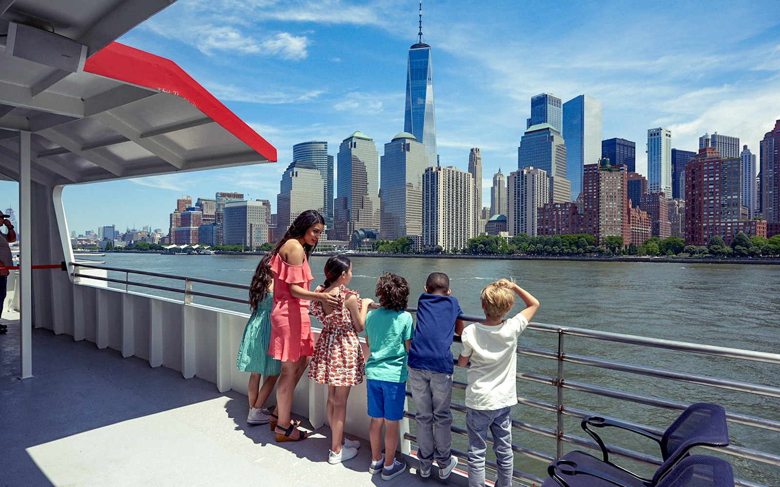 Tourists enjoying the Circle Line Liberty Midtown Cruise with a clear view of the Empire State Building in the background