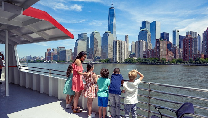 Cruise passengers view New York City skyline, including One World Trade Center, on Circle Line Liberty Midtown Cruise.