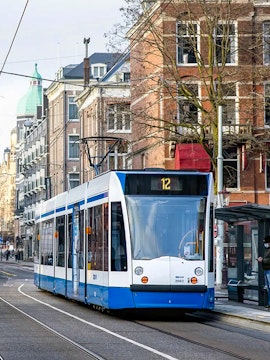 Tram number 12 on a street in Amsterdam, Netherlands, part of the GVB public transport system.