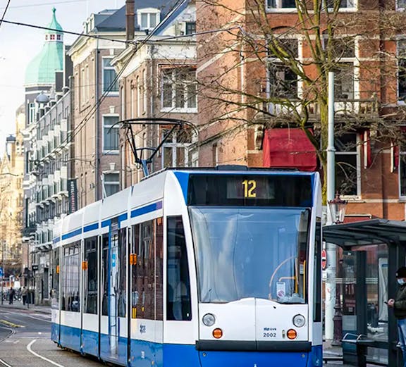 Tram number 12 on a street in Amsterdam, Netherlands, part of the GVB public transport system.