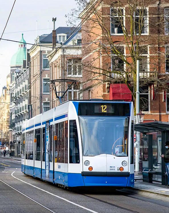 Tram number 12 on a street in Amsterdam, Netherlands, part of the GVB public transport system.