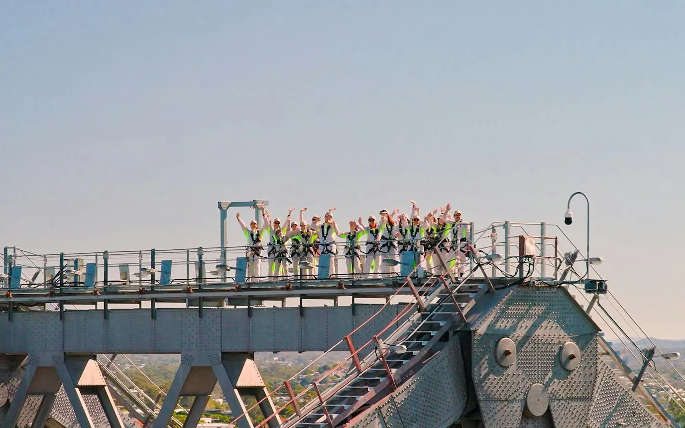 Group climbing Story Bridge in Brisbane, Australia, during adventure tour.