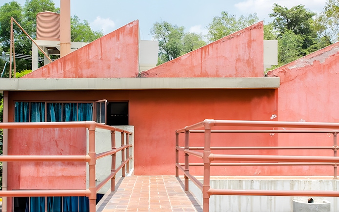 Red facade and walkway at Museo Casa Estudio Diego Rivera y Frida Kahlo, Mexico City.