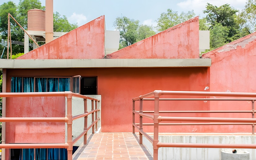 Red facade and walkway at Museo Casa Estudio Diego Rivera y Frida Kahlo, Mexico City.