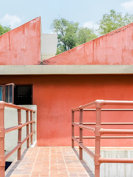 Red facade and walkway at Museo Casa Estudio Diego Rivera y Frida Kahlo, Mexico City.