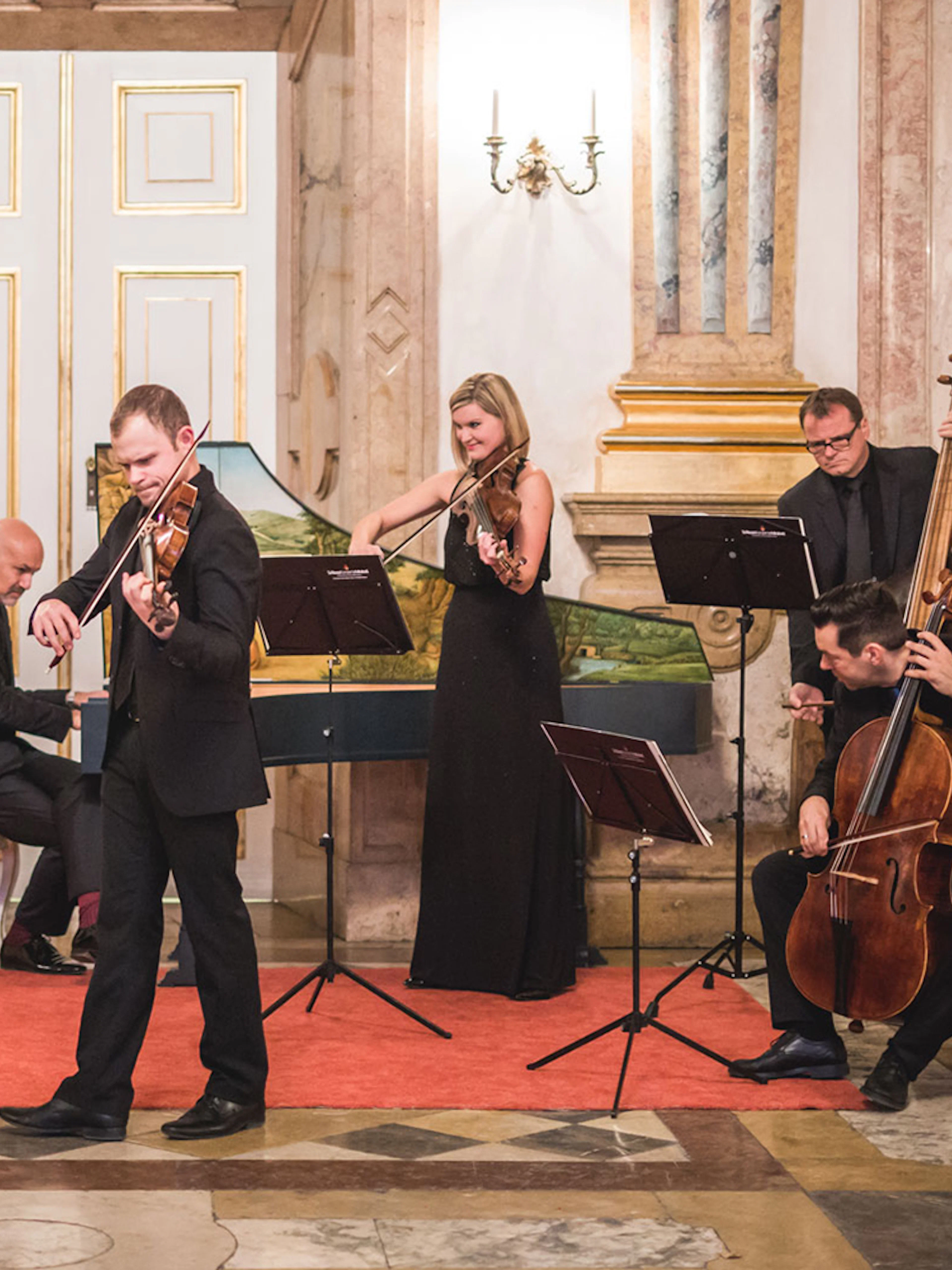 Classical musicians performing at Mirabell Palace concert hall.