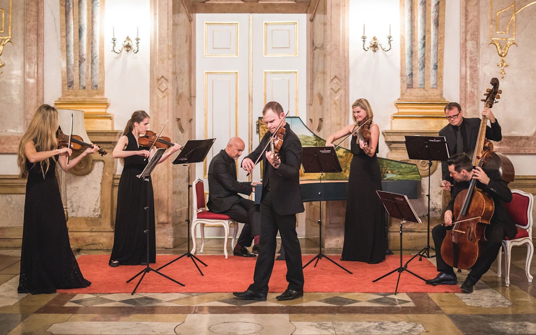 Classical musicians performing at Mirabell Palace concert hall.