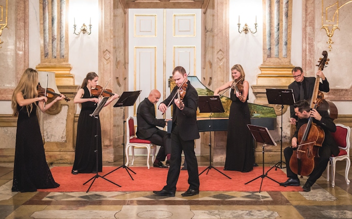 Classical musicians performing at Mirabell Palace concert hall.